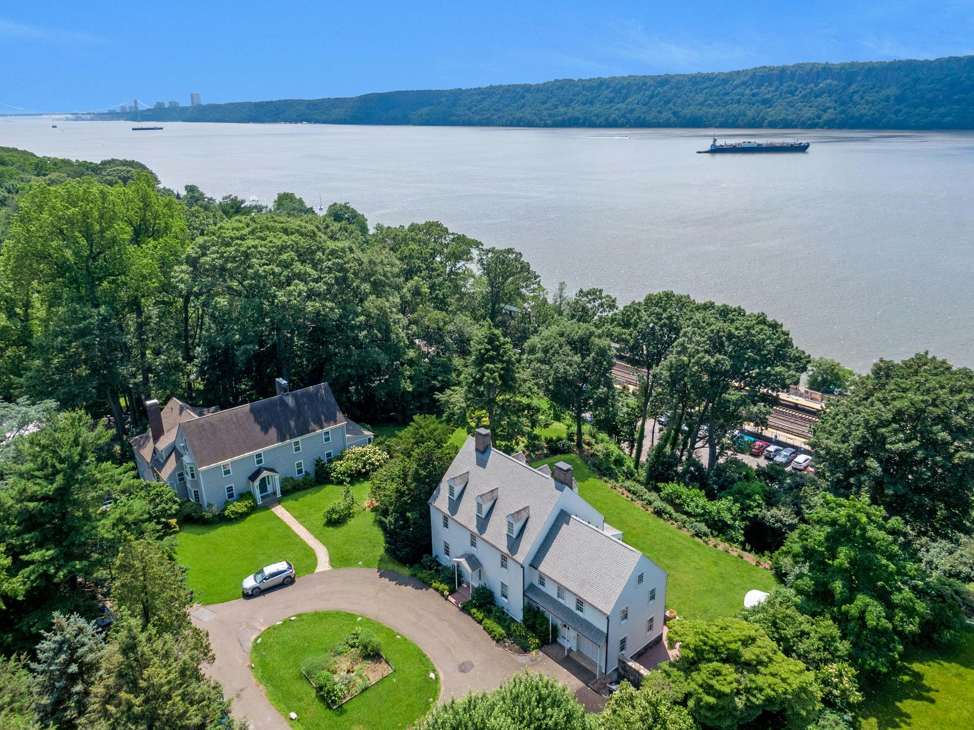 The Hudson, the Palisades, and the house — seen together, a half-acre above the river.